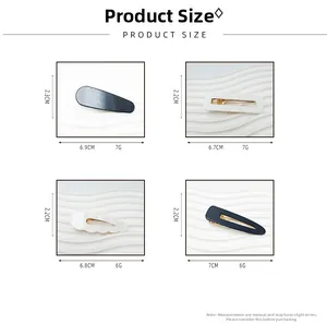 Detailed size chart for minimalist acrylic hair clips in black and creamy white marble