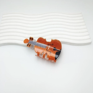 Elegant amber violin shaped hair claw clip made of tortoiseshell acrylic for women