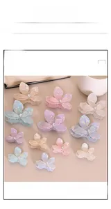 Detailed macro view of colorful pearlescent butterfly hair clips with crystal centers