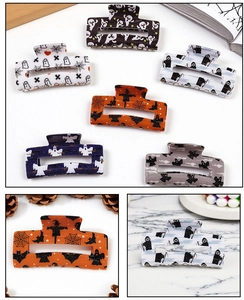 Detail shot of Halloween ghost and bat patterns on high-quality acrylic square hair claws
