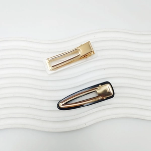 Minimalist black and white acrylic hair clip set with gold metal accents for women