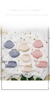 Detailed view of cute ocean shell and whale hair claws with sparkling rhinestones decoration