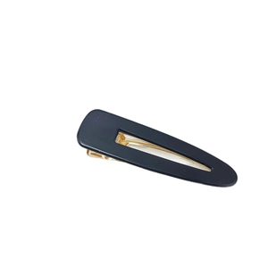 Classic black acrylic hair clip with golden metal base for women in minimalist style