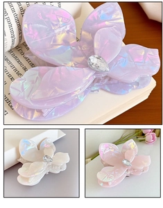 Detail of butterfly claw clips with iridescent finish and teardrop crystal accents
