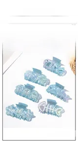 Macro view of blue ocean theme hair clips set including starfish and dolphin shapes