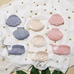 Marine theme hair claws featuring shell and whale shapes with sparkling rhinestones