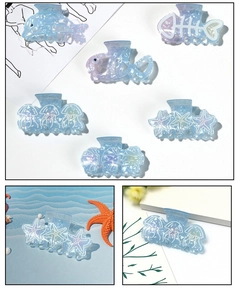 Detail of blue gradient ocean-themed hair clips featuring dolphins and starfish shapes