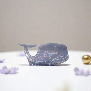 Blue glitter whale hair claw clip with rhinestones and iridescent ocean-inspired design