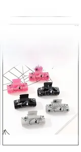 Close-up of glitter Halloween claw clips with spider web and ghost patterns