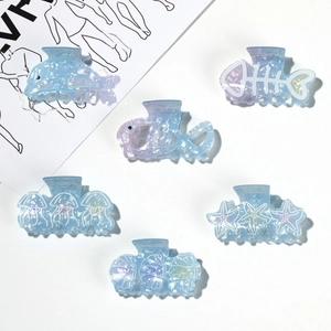 Set of ocean themed hair claws in iridescent light blue seashell and dolphin shapes