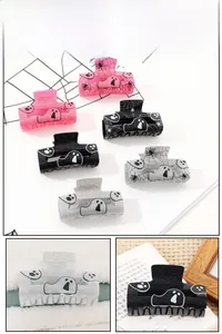 Detailed close-up of glitter Halloween claw clips with ghost and spider web designs