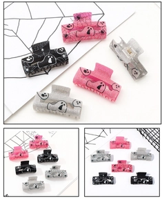 Detail of glitter Halloween hair claws with ghost and spider web patterns in three colors