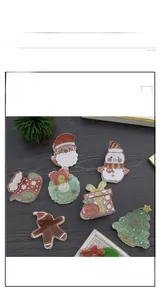 Close-up of festive Christmas hair claws featuring glittery Santa, snowman, and tree designs