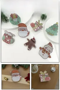 Macro view of Christmas glitter acrylic hair clips featuring Santa, elk, and snowman motifs