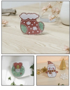 Detail view of acrylic Christmas hair clips featuring snowman and wreath with festive glitter