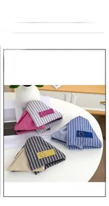 Detail of fabric shark hair clips with stripe patterns and smile face patch labels