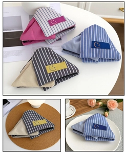 Striped fabric triangular glasses pouches with minimalist smiley face patch details