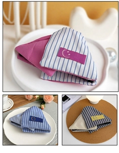Detail of triangular striped fabric hair claws with cute smile patch for women