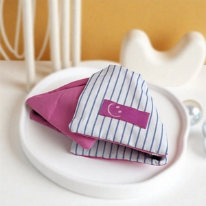Magenta and blue striped fabric hair clip with a minimalist white smiley face icon