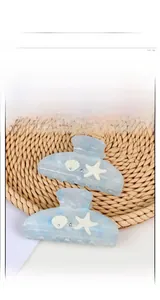 Detail of blue marble ocean theme hair clips with starfish and seashell embellishments