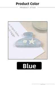 Detail of blue marble claw clip with starfish and seashell charms on fabric background