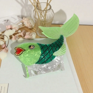 Elegant ocean themed fish shaped hair claw with green and pearl white marble patterns