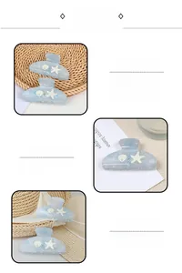 Detailed view of ocean-themed starfish and shell hair claws with blue marble acetate texture