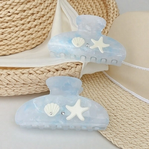 Ocean-inspired starfish shell hair claw clips with blue marble pattern on straw hat