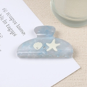 Blue marble hair claw clip with white starfish and seashell charms and crystals