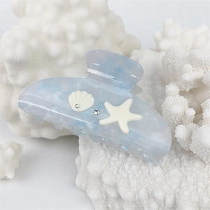 Blue marble texture hair claw clip with starfish and seashell ornaments for beach vacation
