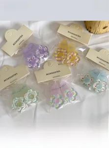 Detail view of five colorful jelly floral hair clips with cute printed flower patterns