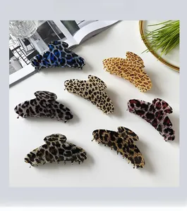 Detailed set of six leopard print hair claws in vibrant colors with resin texture