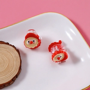 Sweet Santa Claus mini hair claws for Christmas hairstyles on pink background