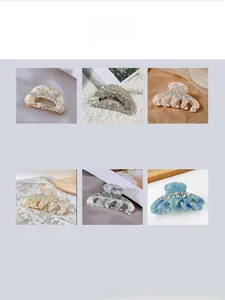 Detailed view of luxury rhinestone pumpkin hair claws in six varied marble colors