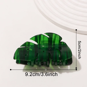 Green Monstera leaf hair claw clip made of translucent acetate, 9.2cm length shown on white
