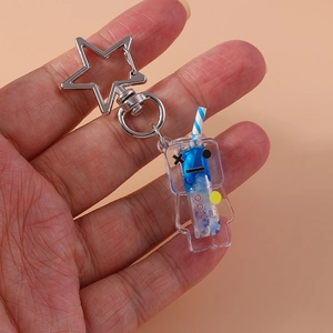Close-up of creative star-shaped metal clasp and glowing liquid robot keychain charm