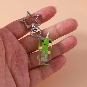 Luminous fluid robot keychain with green liquid and star buckle held by hand
