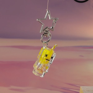Glow-in-the-dark luminous yellow juice cup keychain with star clasp on pink background