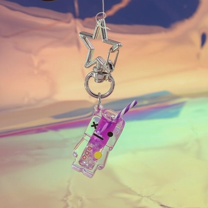 Close-up of purple liquid keychain with star metal clasp and straw detail on laser background