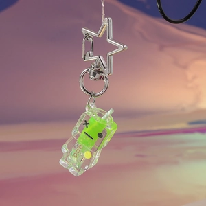 Luminous green robot keychain with star-shaped silver clasp on gradient background