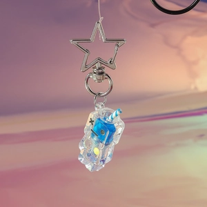 Macro detail of star clasp and glowing beverage keychain with blue liquid filling