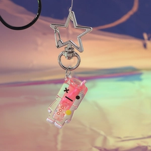 Detailed macro view of creative glowing drink keychain with pink liquid and star metal clasp