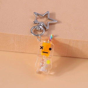 Detailed close-up of a robot fluid keychain with orange liquid and silver star clasp
