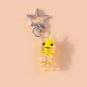 Close-up of creative luminous juice drink keychain with silver star clasp on pink background