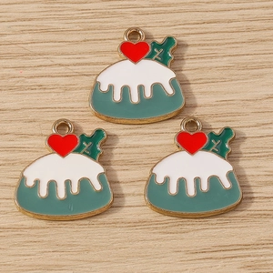 Detailed macro view of 3 enamel pudding charms with red hearts on light wood background
