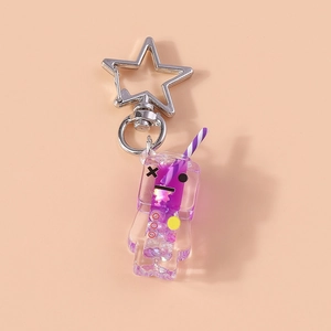 Detail of purple luminous drink keychain with star clasp and sparkling glitter filling