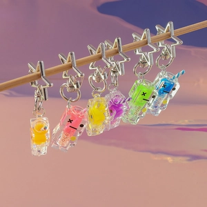 Close-up of colorful glow-in-the-dark drink bottle keychains with star-shaped clips