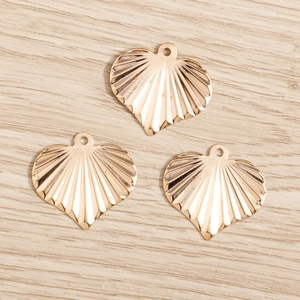 Macro detail of gold plated heart pendants with unique radial texture and top bail