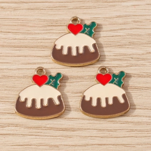 DIY cake dessert pendant with cream and red heart detail on light wood background