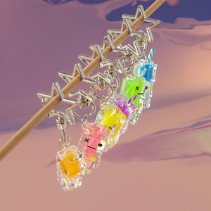 Detailed view of colorful luminous juice box charms with star-shaped metal clasps